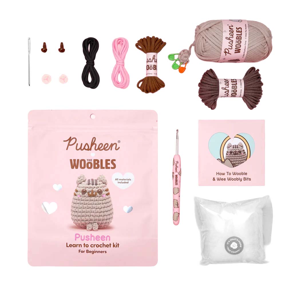 Crochet kit with yarn, hooks, and a Pusheen branded card on a white background