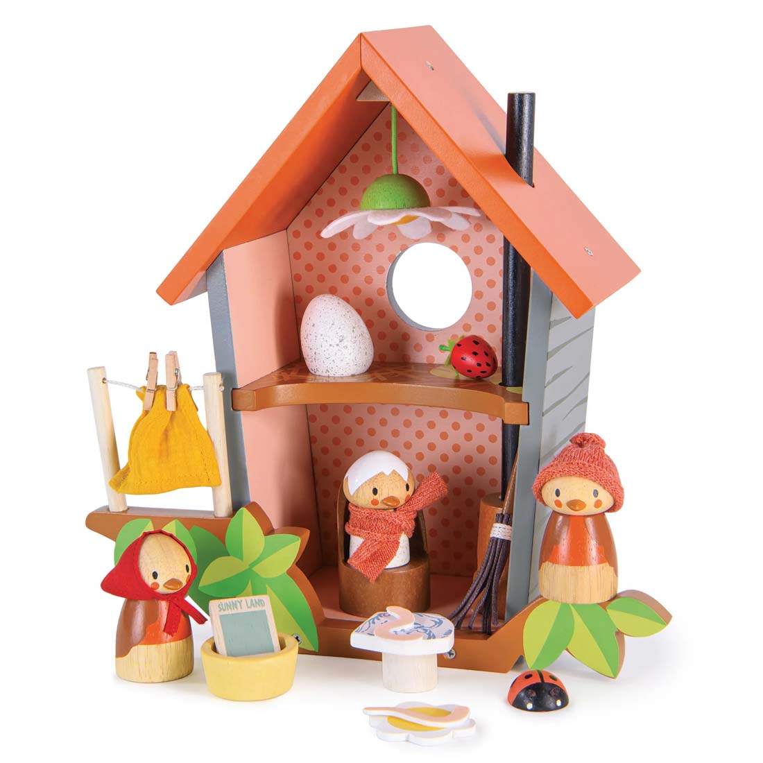 Wooden toy house with characters and accessories on a white background