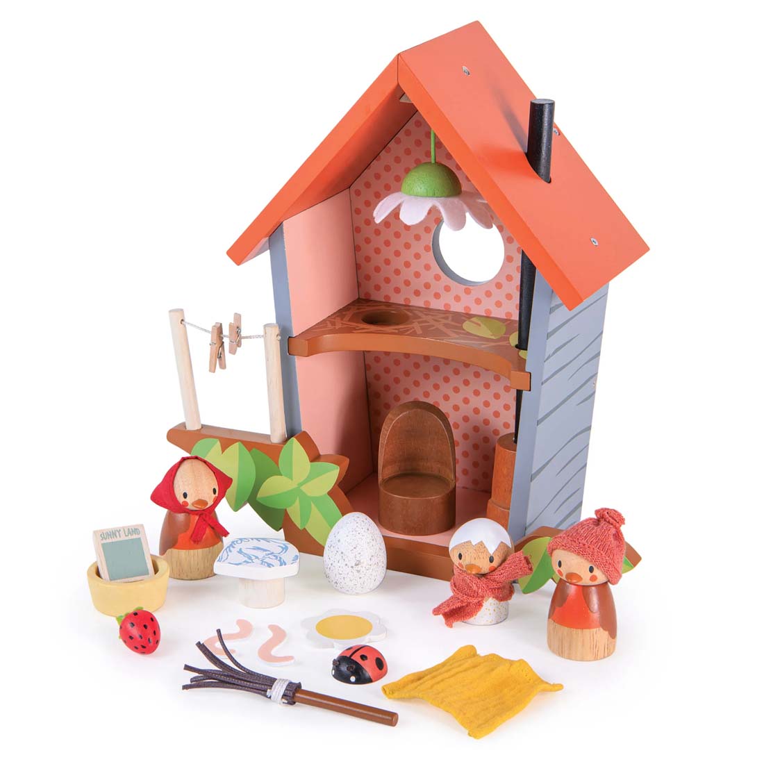 Wooden toy house with characters and accessories on a white background