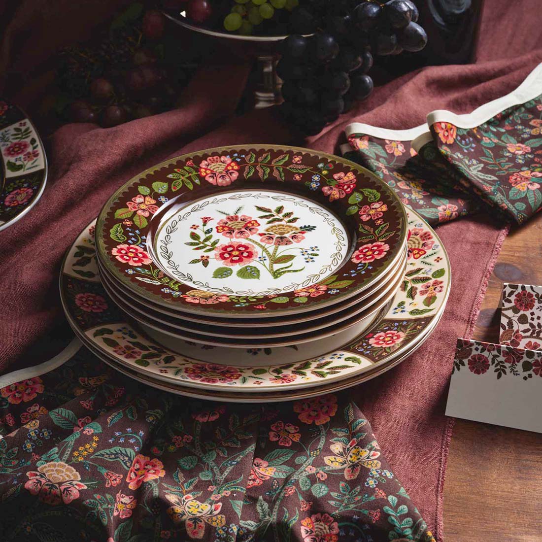 Set of four decorative plates with floral patterns on a white background