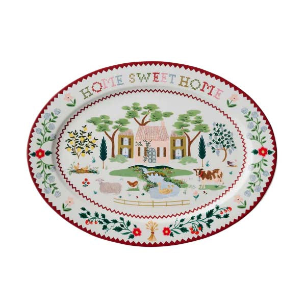 Decorative plate with 'Home Sweet Home' text and a village scene.