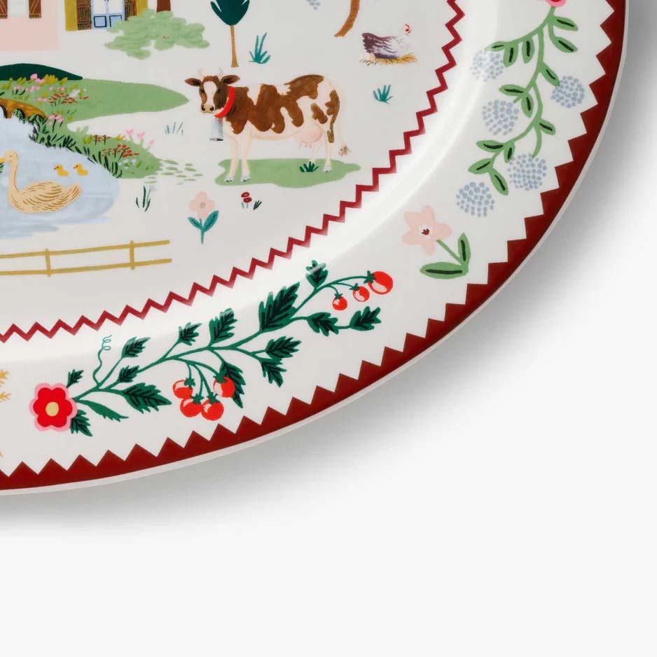 Decorative plate with 'Home Sweet Home' text and a village scene.