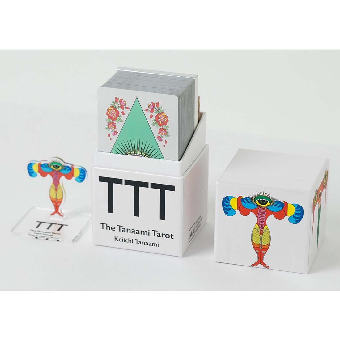 Three tarot card boxes with colorful designs on a white background