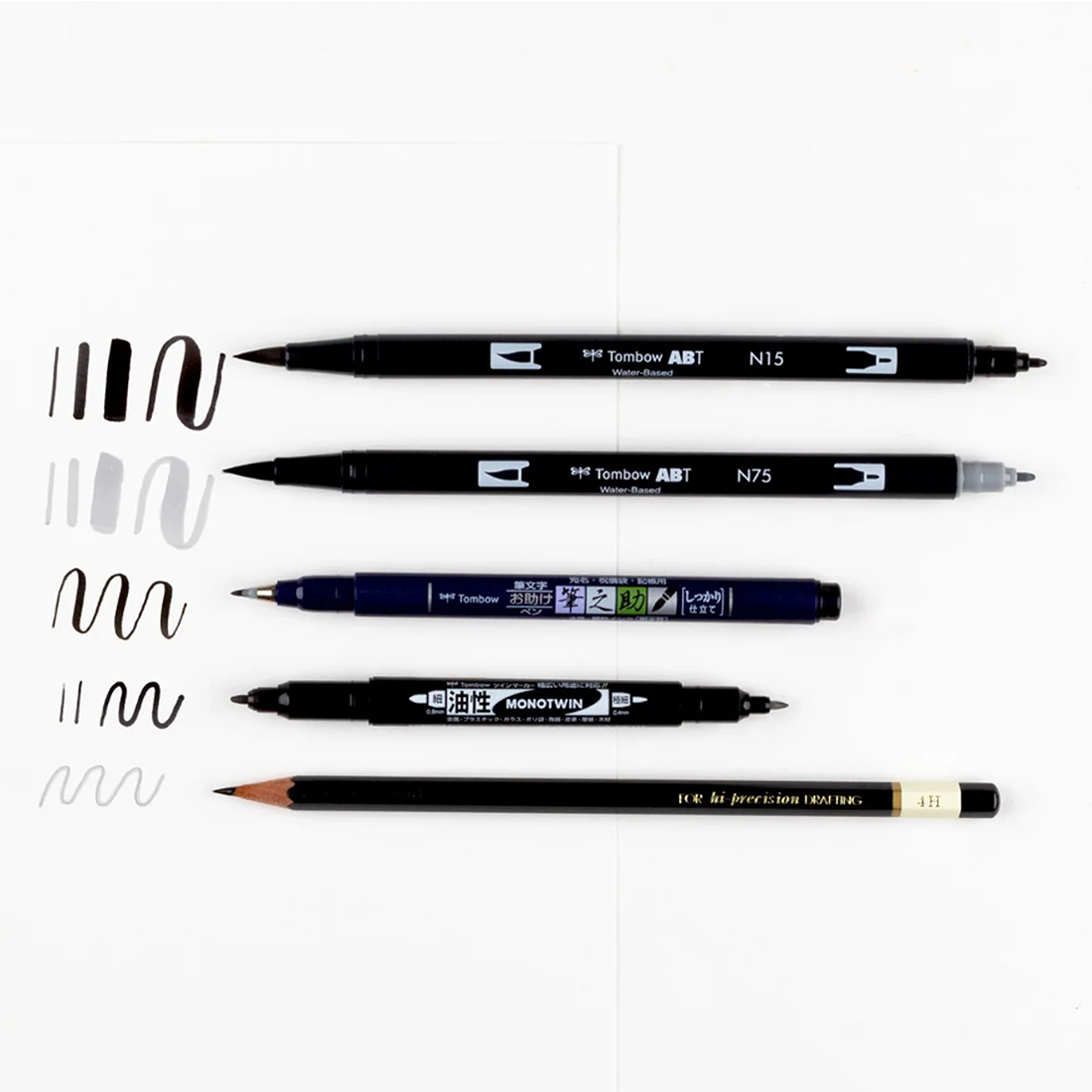 Set of Tombow art supplies including markers and a pencil on a white background