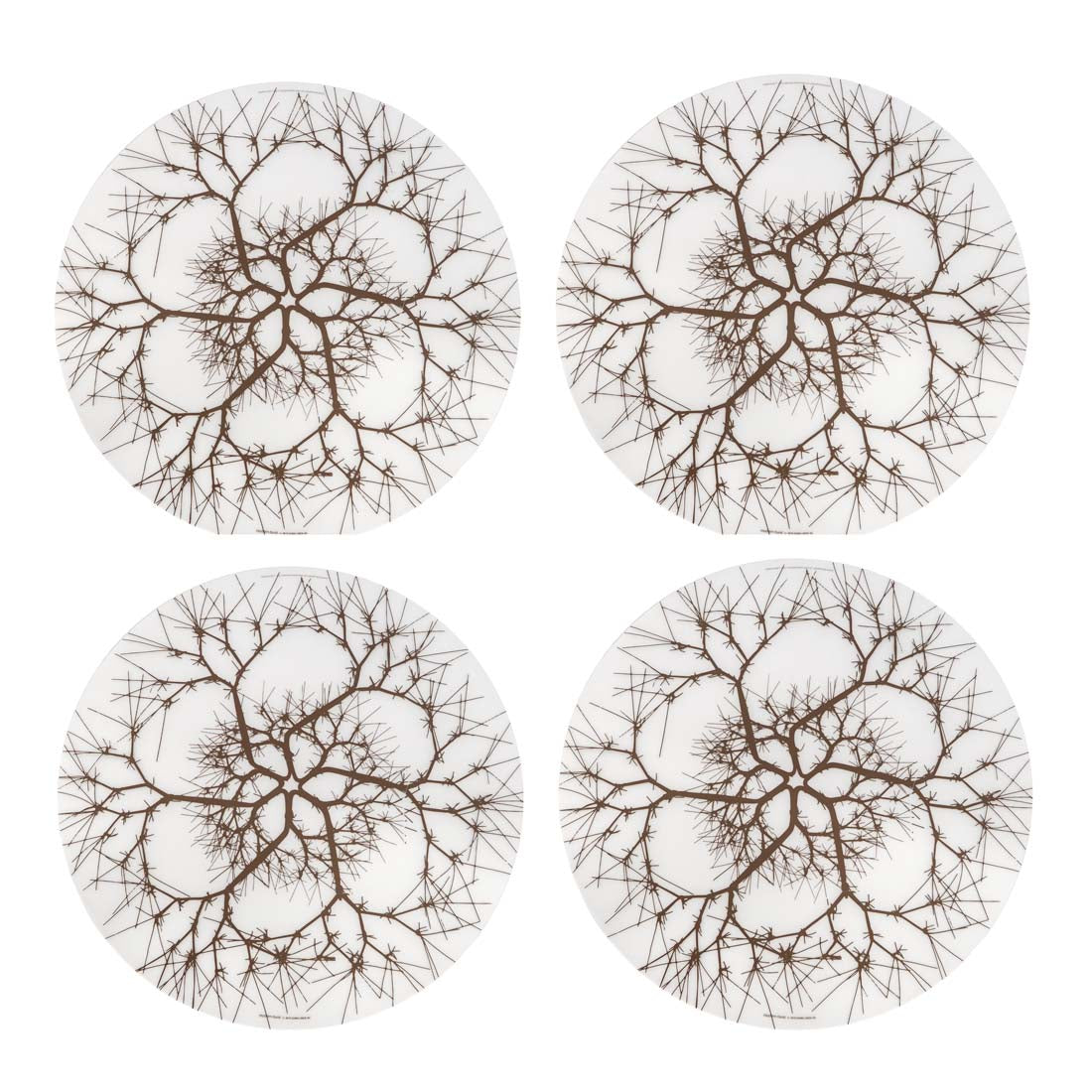 Four round coasters with tree branch pattern on a white background