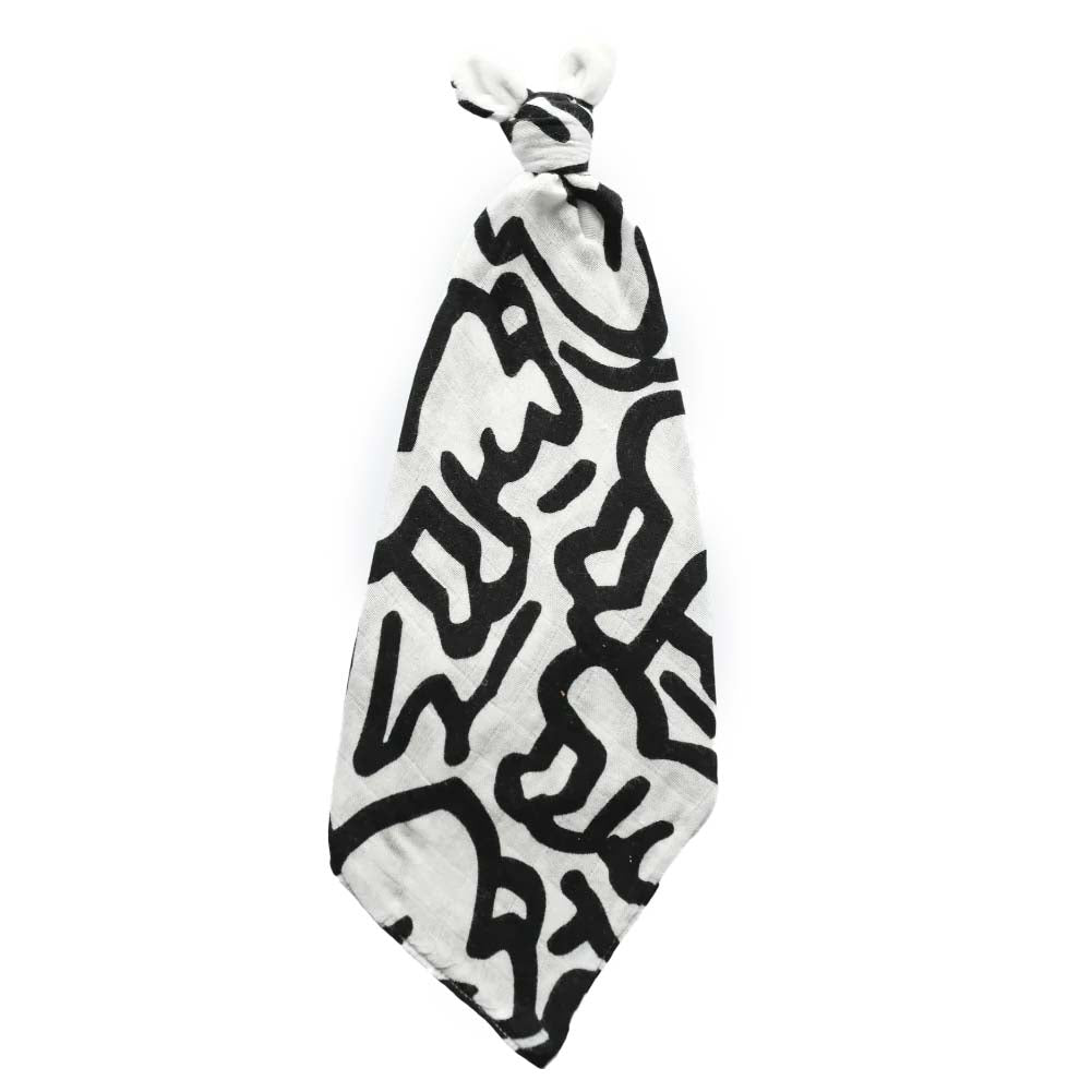 A black and white security blanket with a geometric pattern, featuring plush ears.