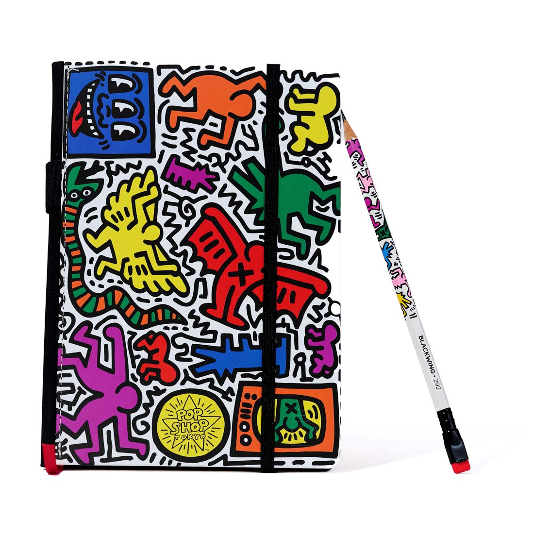 Colorful notebook with abstract designs and a matching pen on a white background