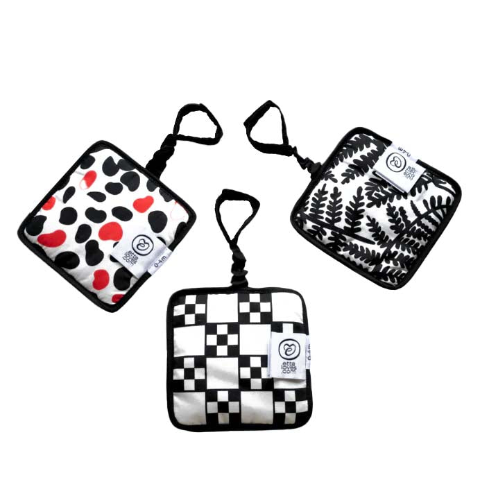 Three baby sensory hanging squares with various patterns, including a leaf design, a geometric pattern, and a mirror design, displayed against a white background.