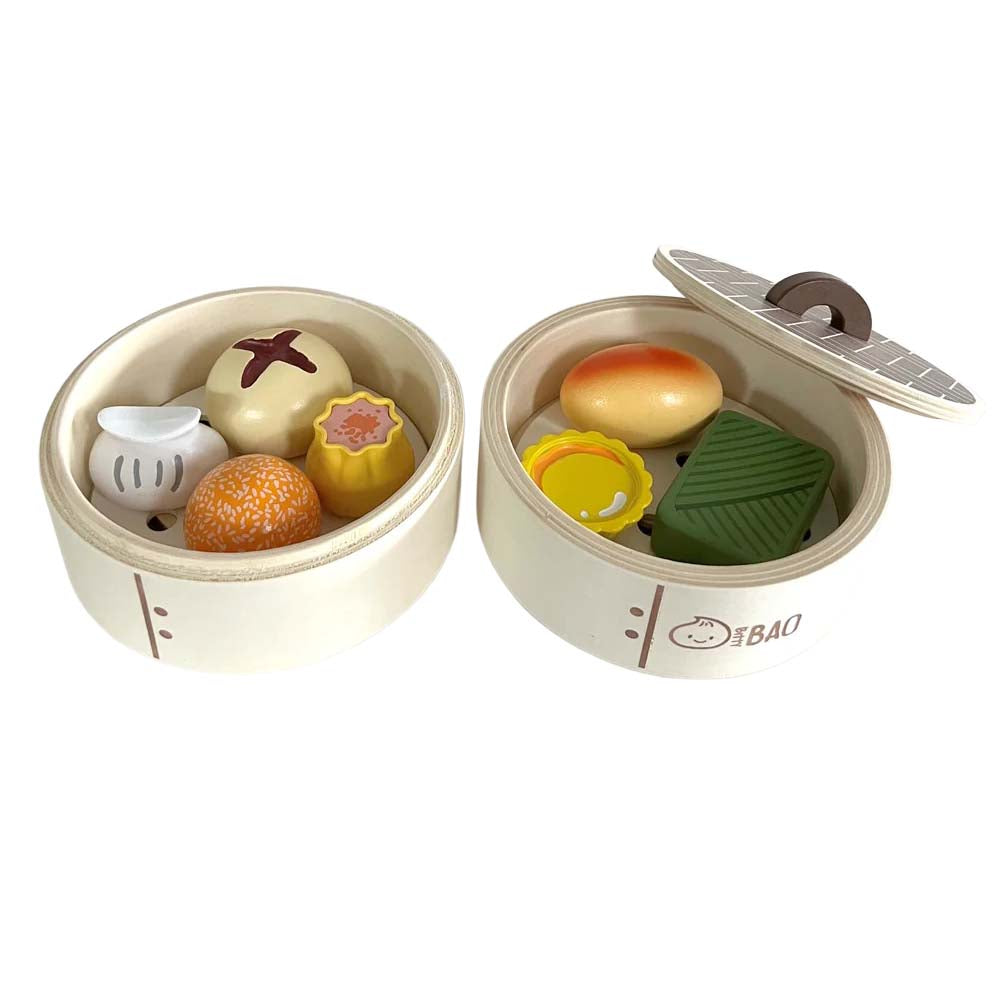 Toy set resembling a steamer basket with various food items on a white background