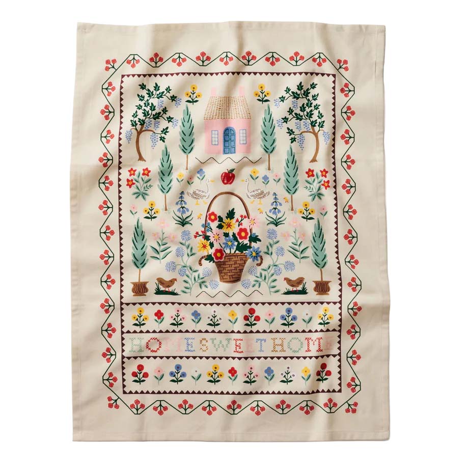 Embroidered tea towel with floral design and text on a white background