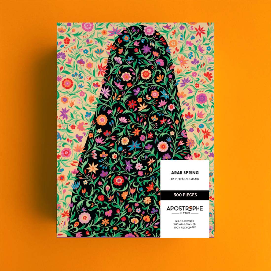 A 500 piece jigsaw puzzle depicting a colorful floral pattern with a silhouette of a figure, packaged in a box with the name 'Arab Spring' and the artist's name 'Helen Zughaib'.