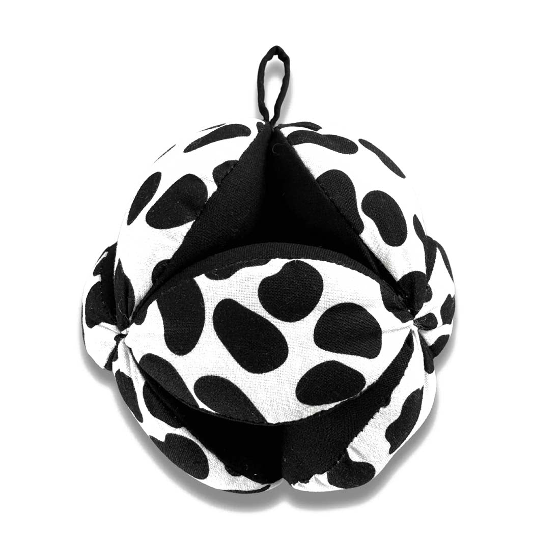 A black and white polka-dotted sensory grasp ball with a hook for hanging.