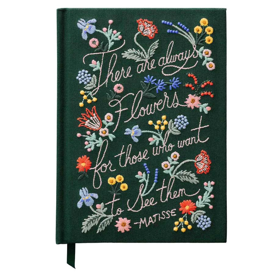 Decorative notebook with floral embroidery and text on a white background