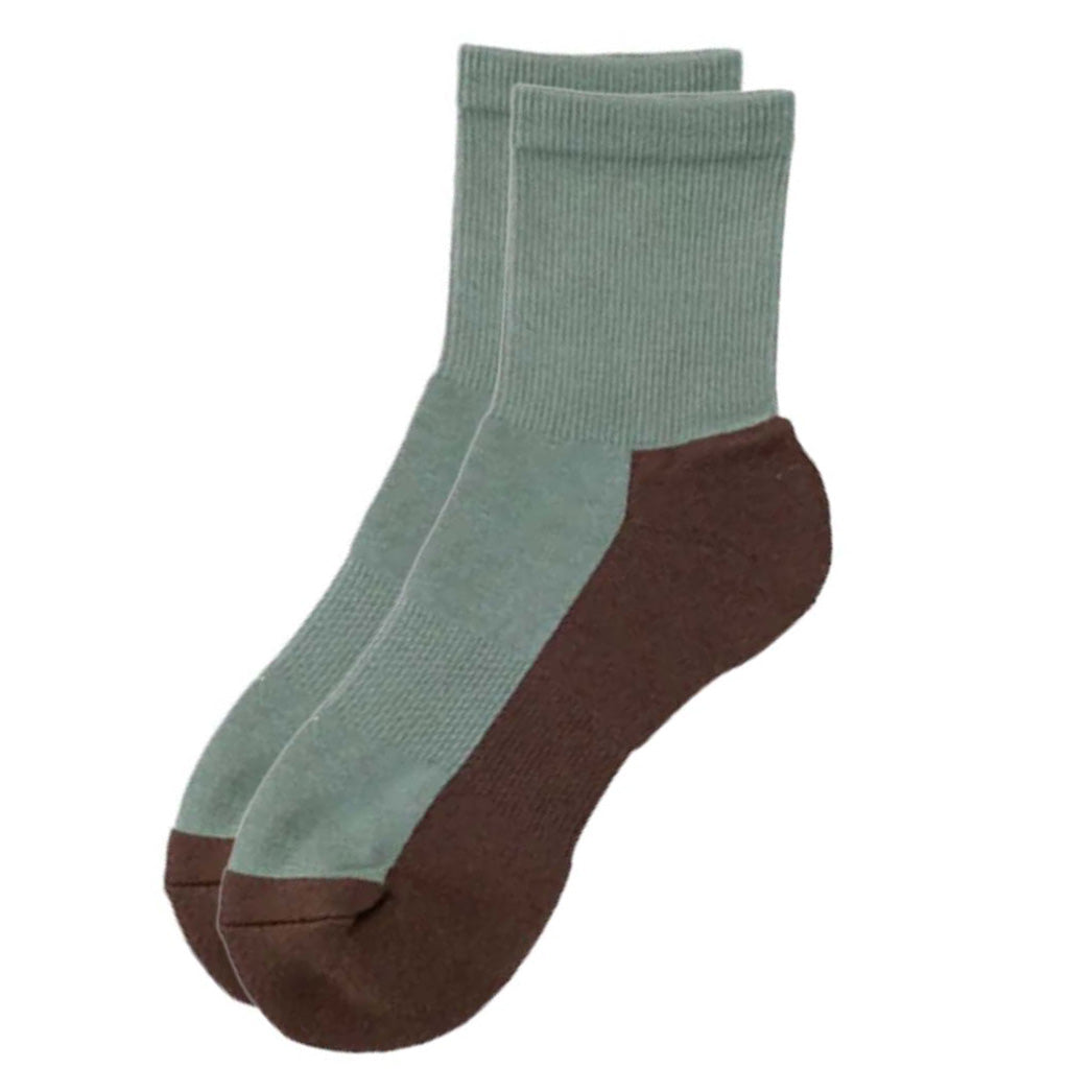 Pair of socks with green top and brown bottom on a white background