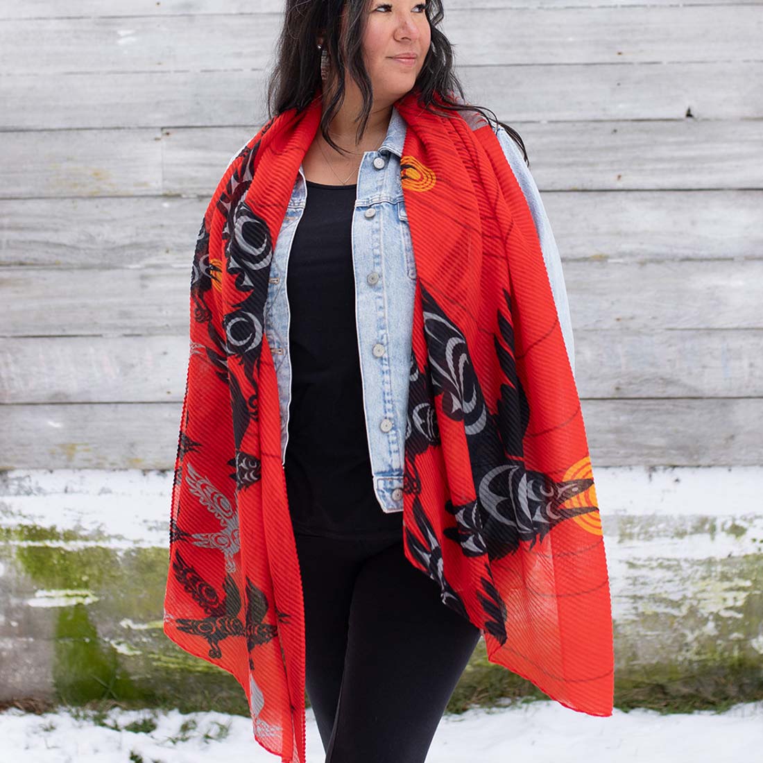 A red scarf with black and gray patterns, displayed on a plain background.