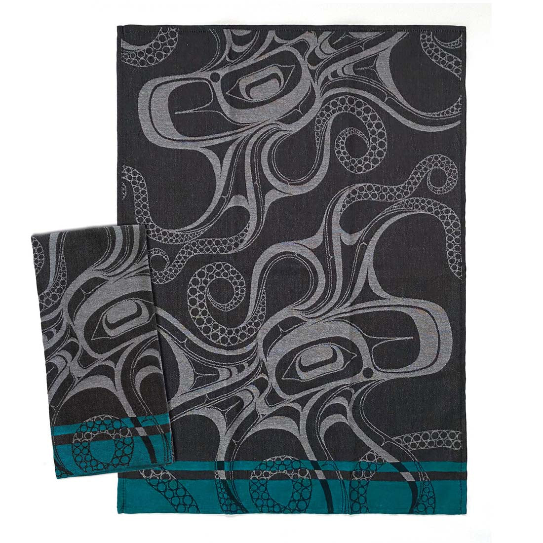 A black cotton tea towel with a white octopus pattern and a teal blue border.
