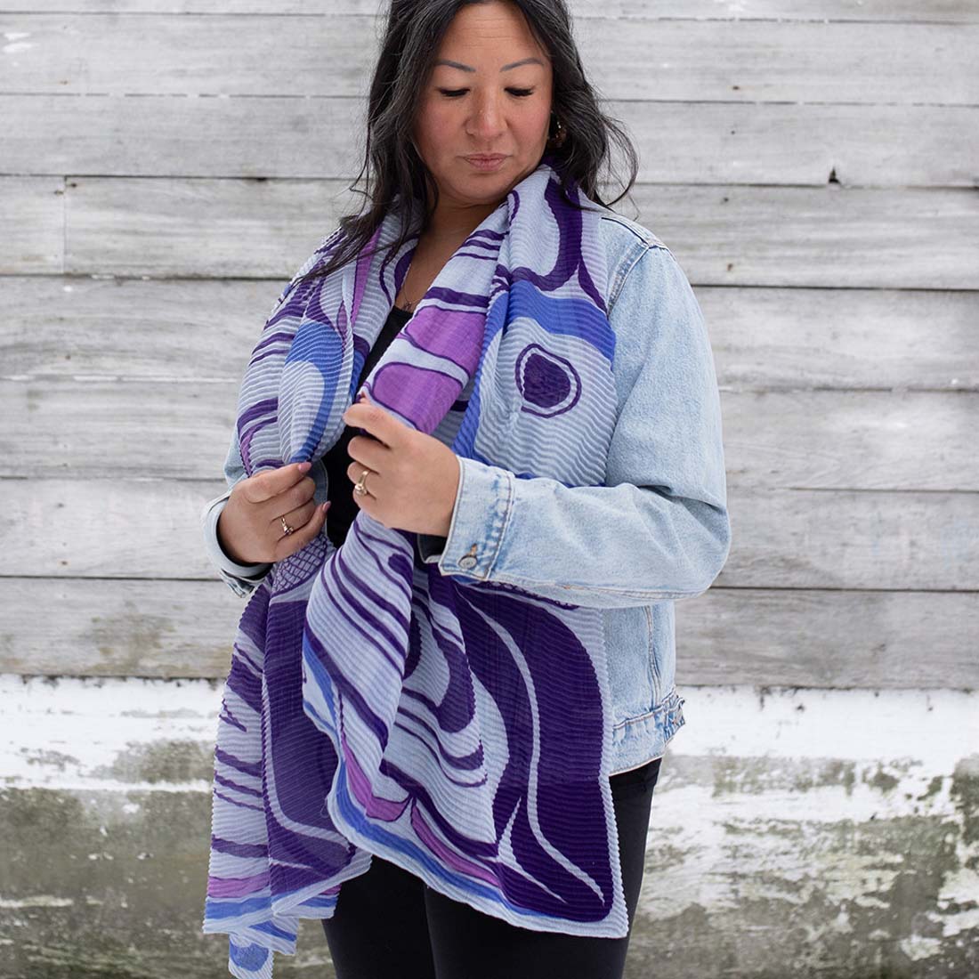 An eco scarf with a geometric pattern in shades of blue and purple, displayed flat.