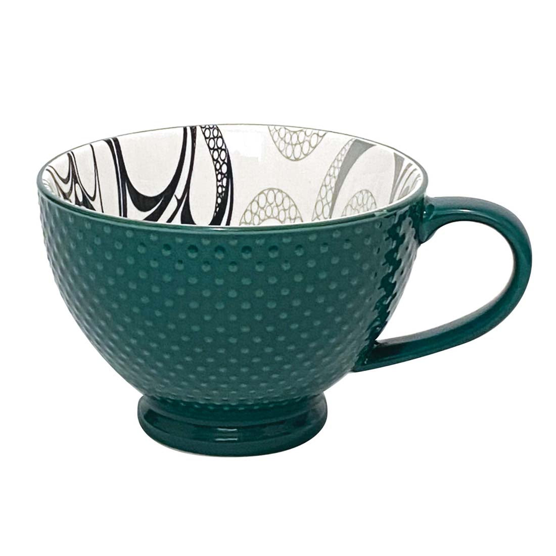 A dark green ceramic mug with a contemporary Indigenous design on the interior and a textured exterior.