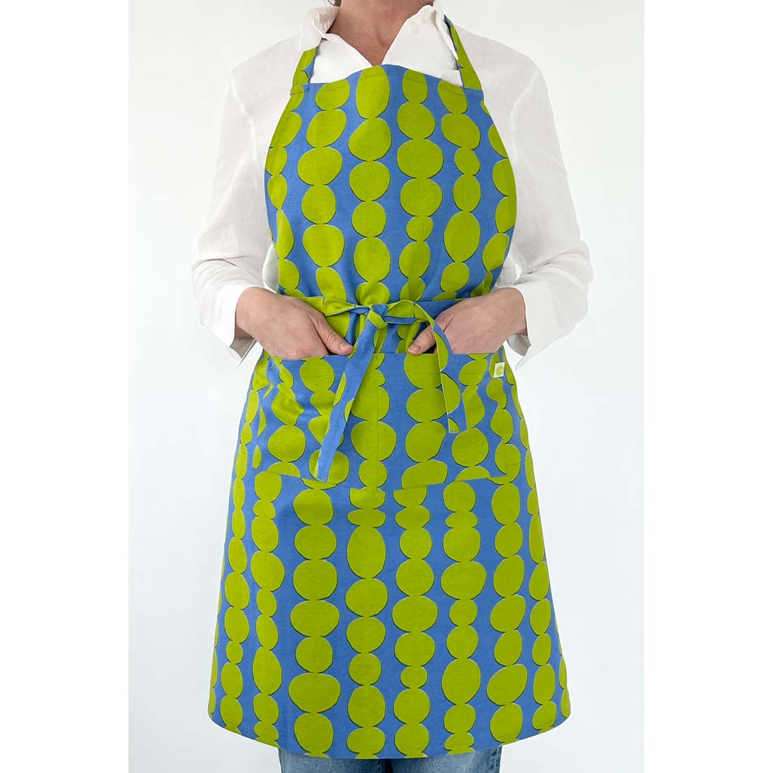 Blue apron with green circular pattern on a white background