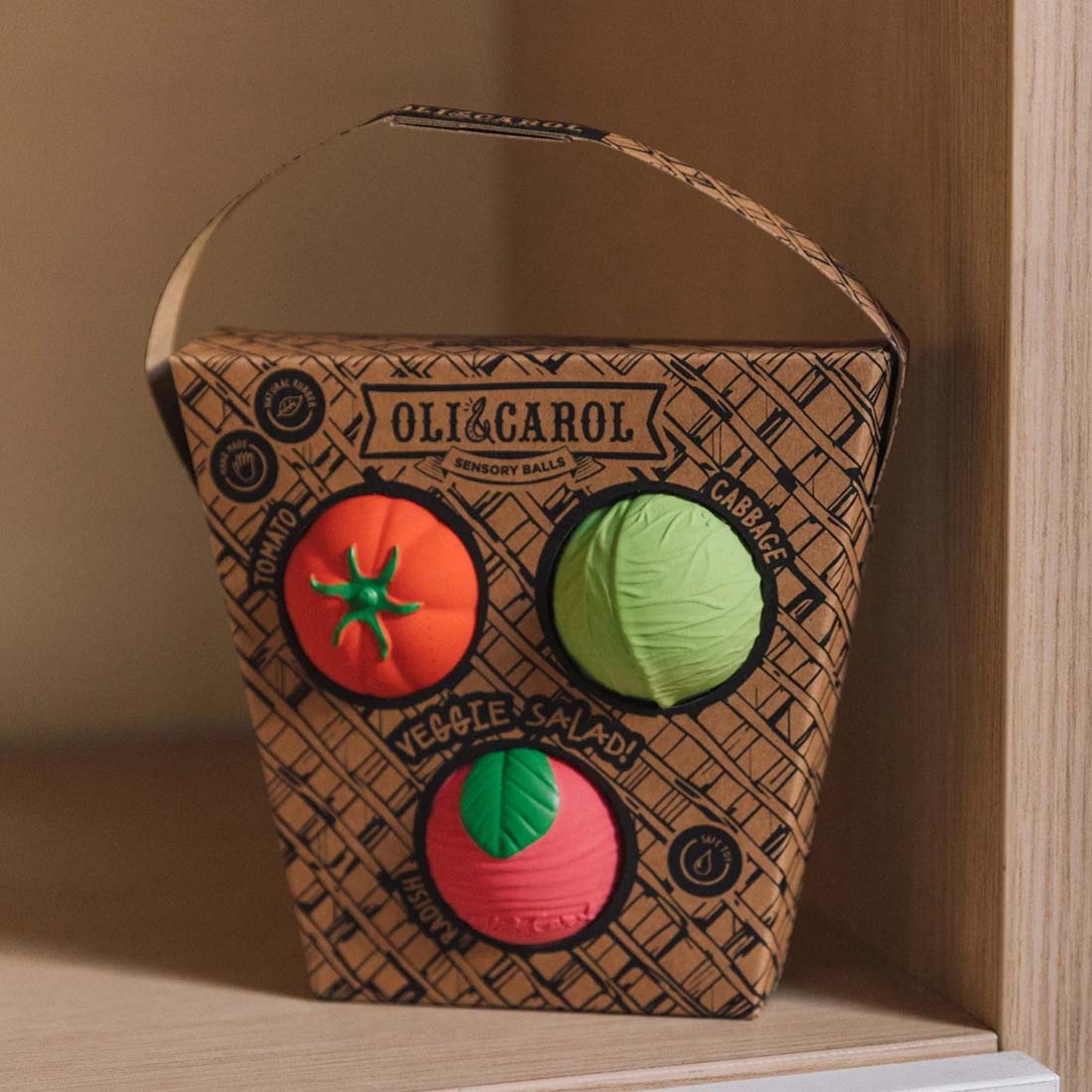 Oli & Carol sensory balls in a cardboard box on a white background