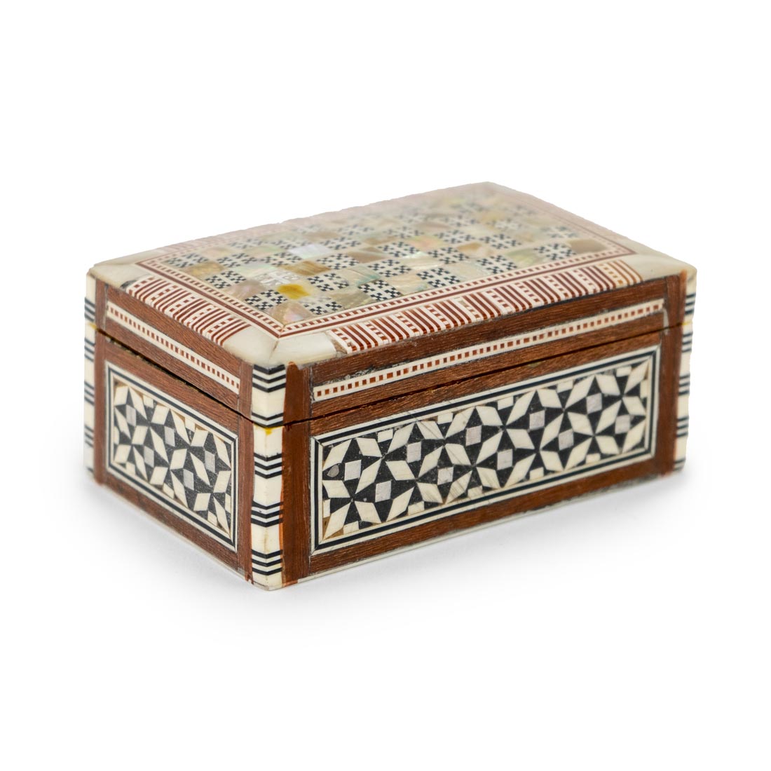A small rectangular box with geometric mother-of-pearl inlays on the lid and a patterned fabric hinge.