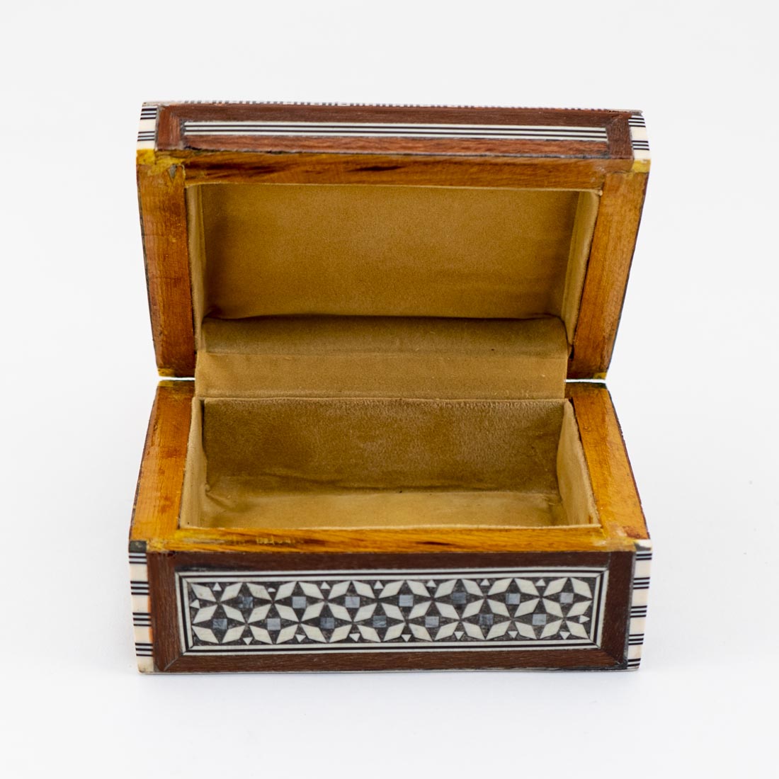 A small rectangular wooden box with geometric mother of pearl inlay on the lid.