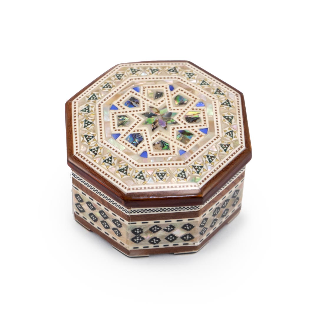 A handcrafted wooden box with hexagonal shape and geometric design made of mother-of-pearl inlaid into the surface.