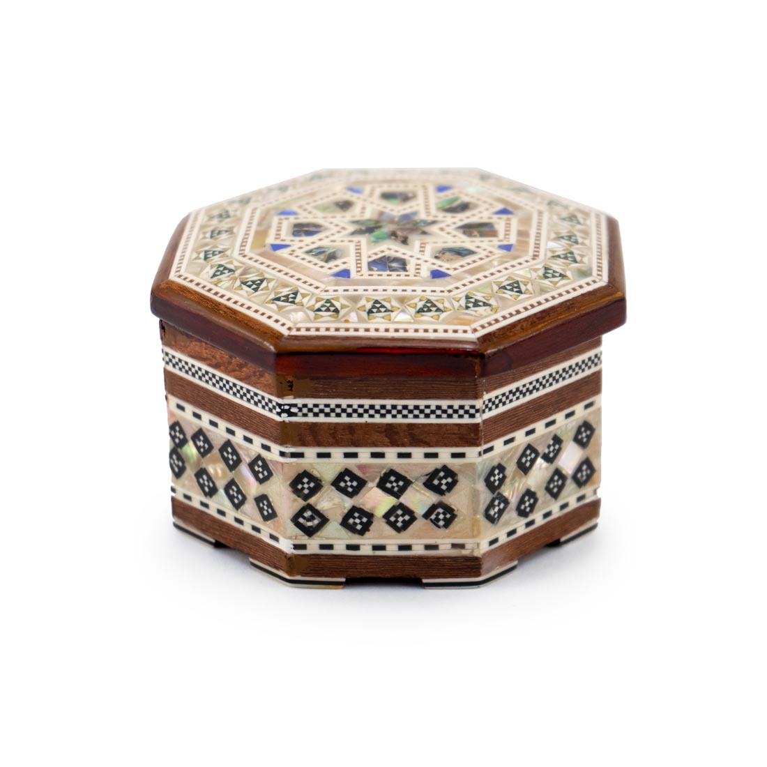 A handcrafted wooden box with hexagonal shape and geometric design made of mother-of-pearl inlaid into the surface.
